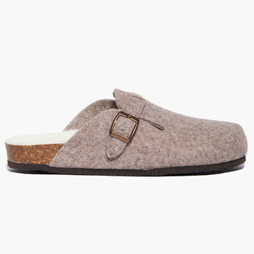 A beige wool felt slipper with a adjustable strap and a cork insole,on a white background. Handmade in Spain.